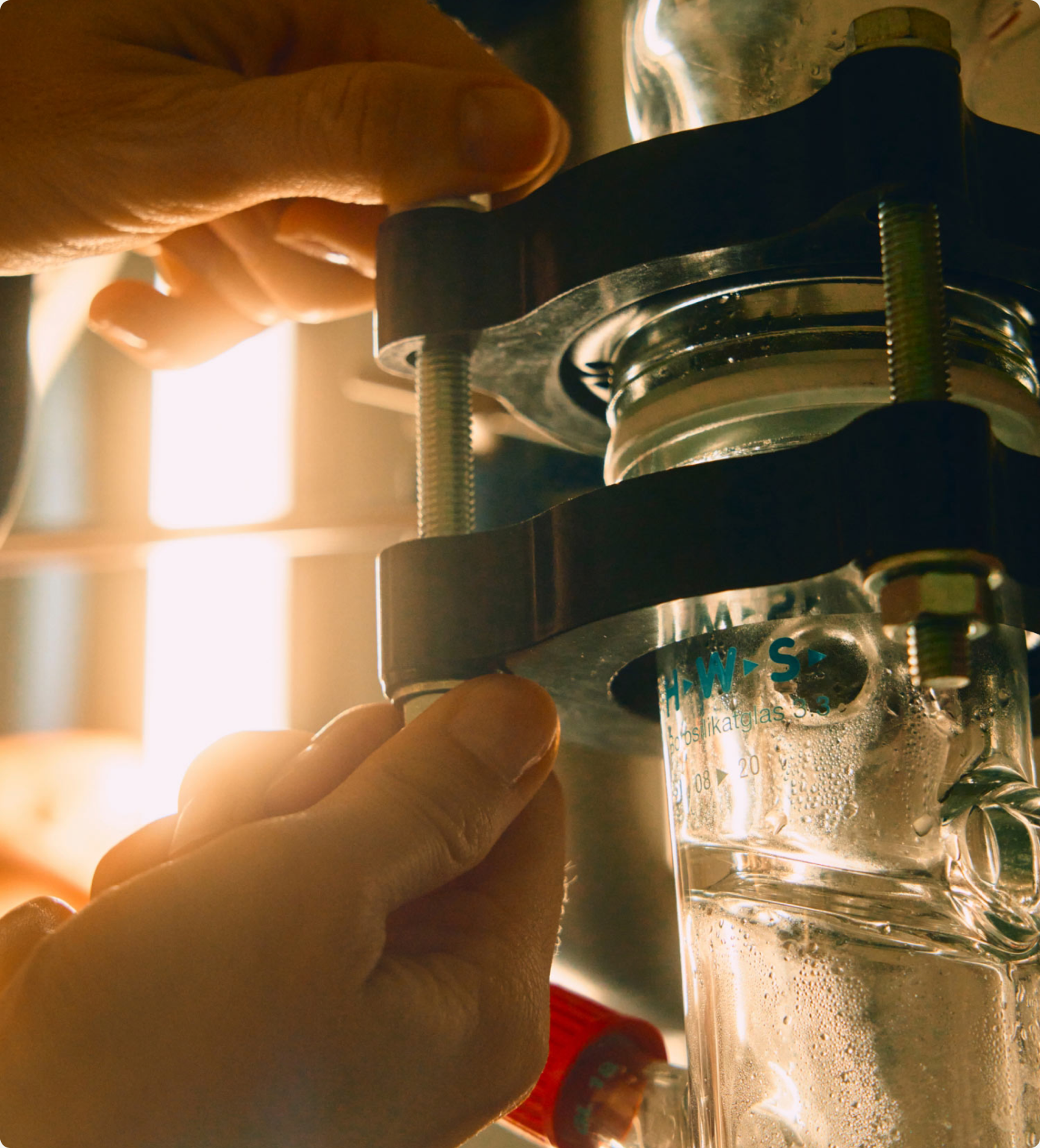 Close lab photography of glassware lit like a campaign