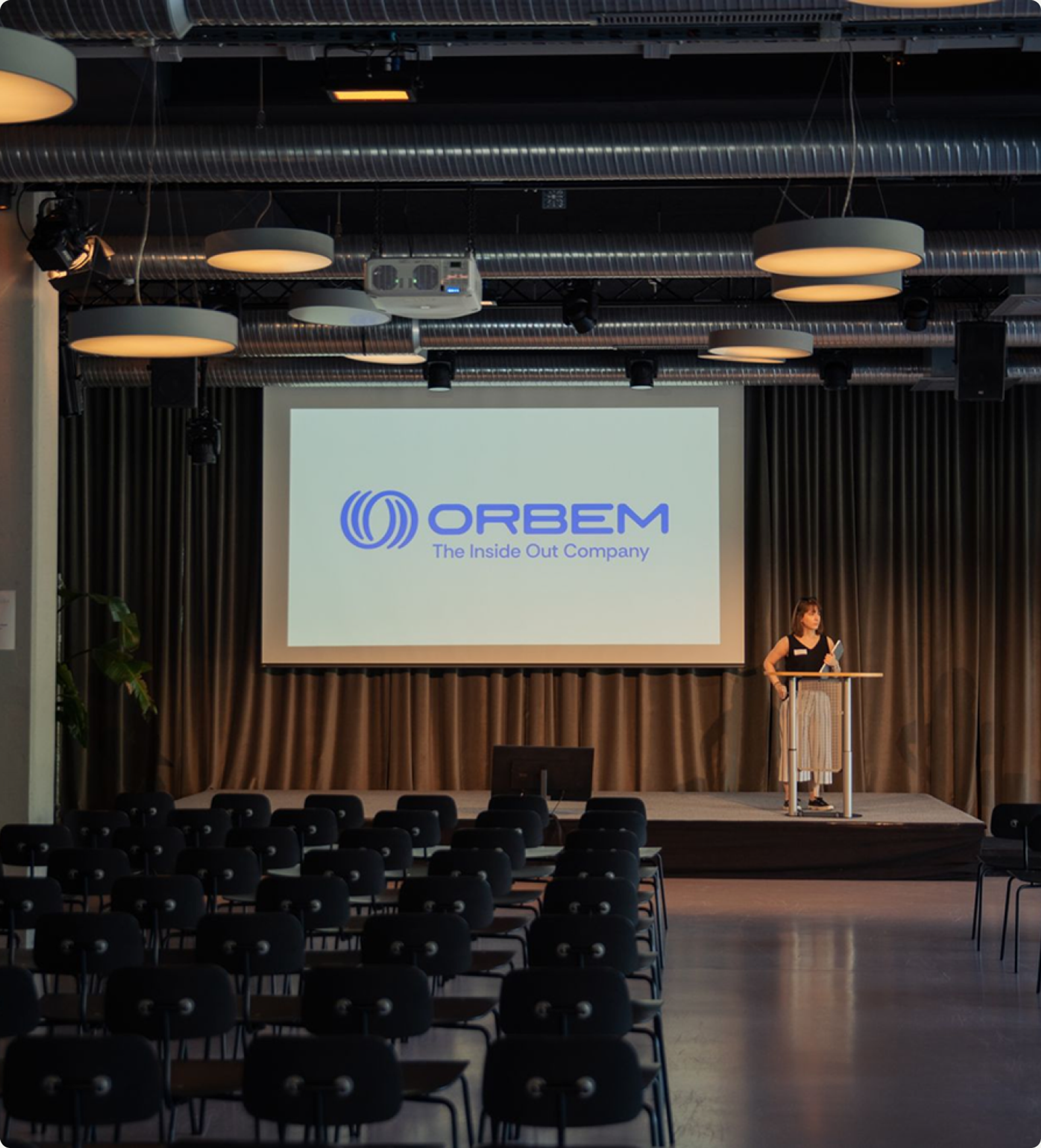 Orbem logo and The Inside Out Company line on an auditorium screen