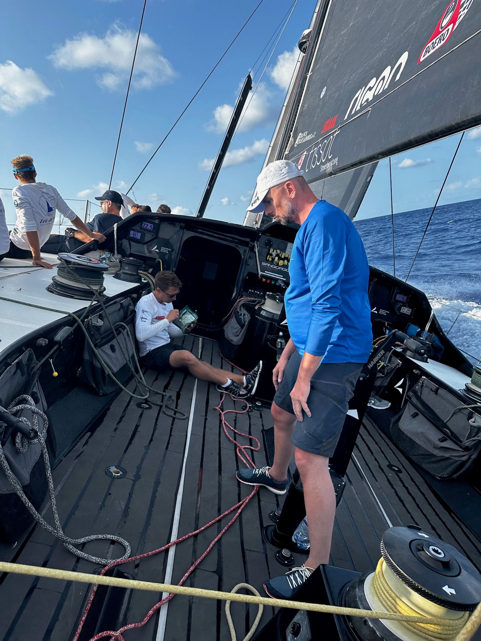 Looking aft across the VO65’s carbon deck at sea, the speed display reading 22.5 knots
