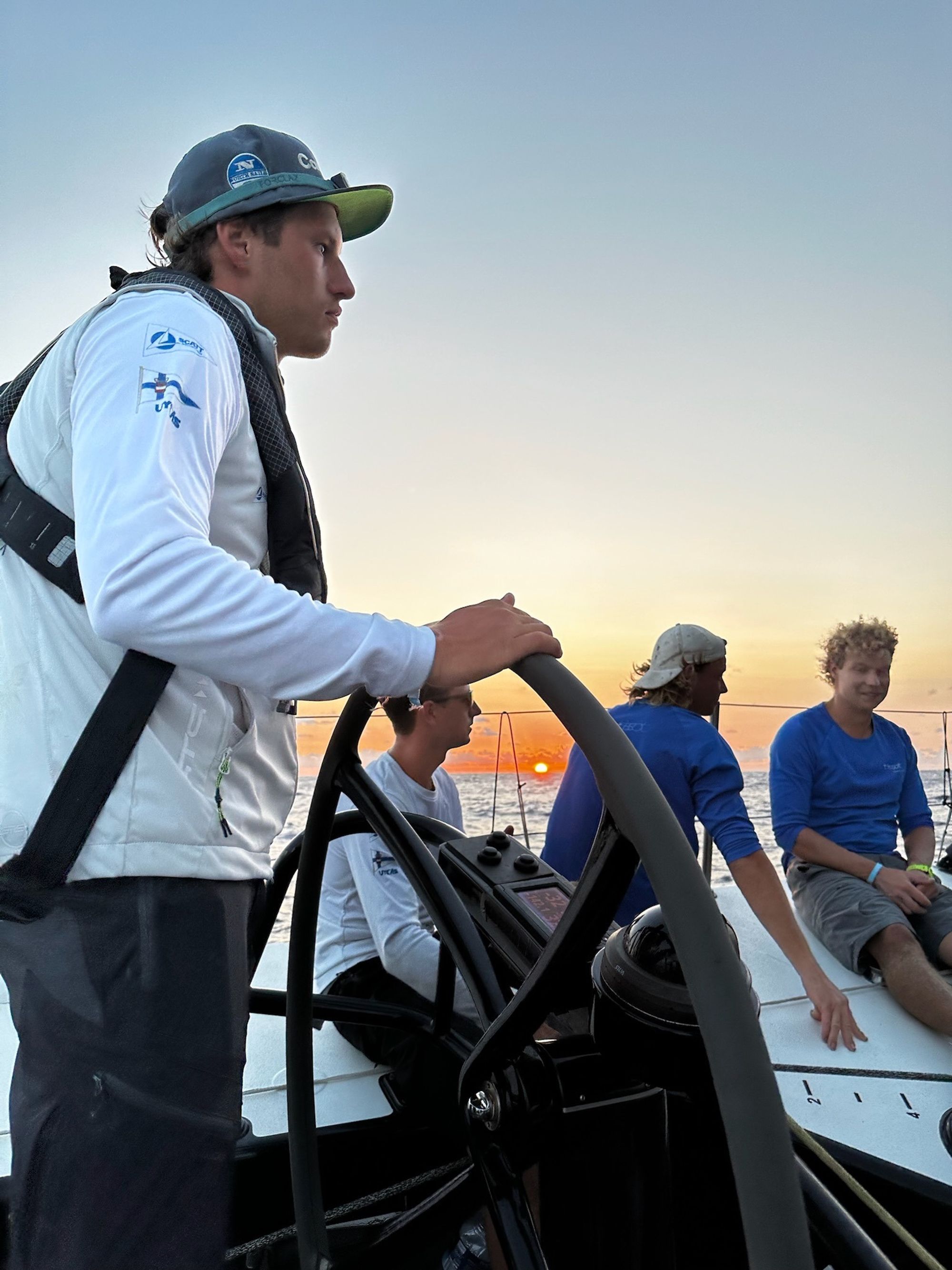 At the wheel at sunset, the crew in the cockpit