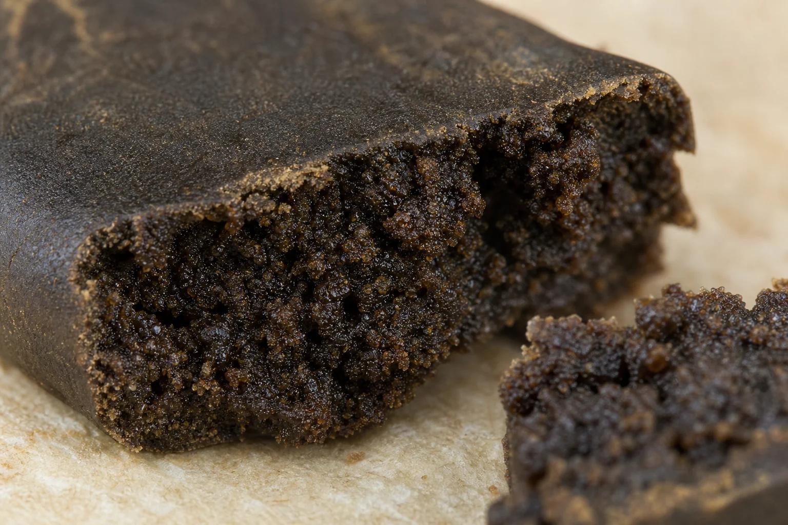 Close-up of dark brown traditional cannabis hash interior