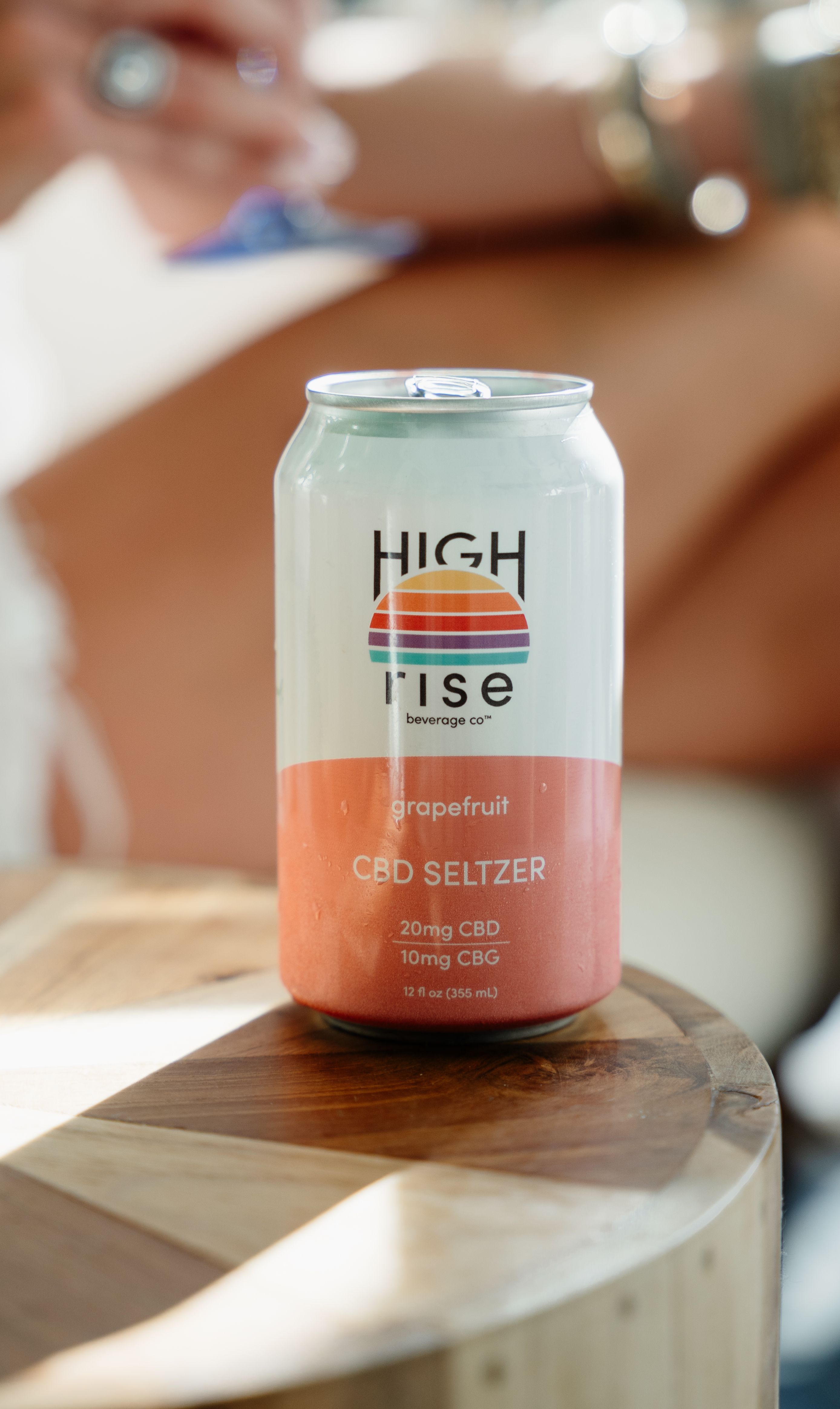 high rise grapefruit seltzer sitting on wooden table