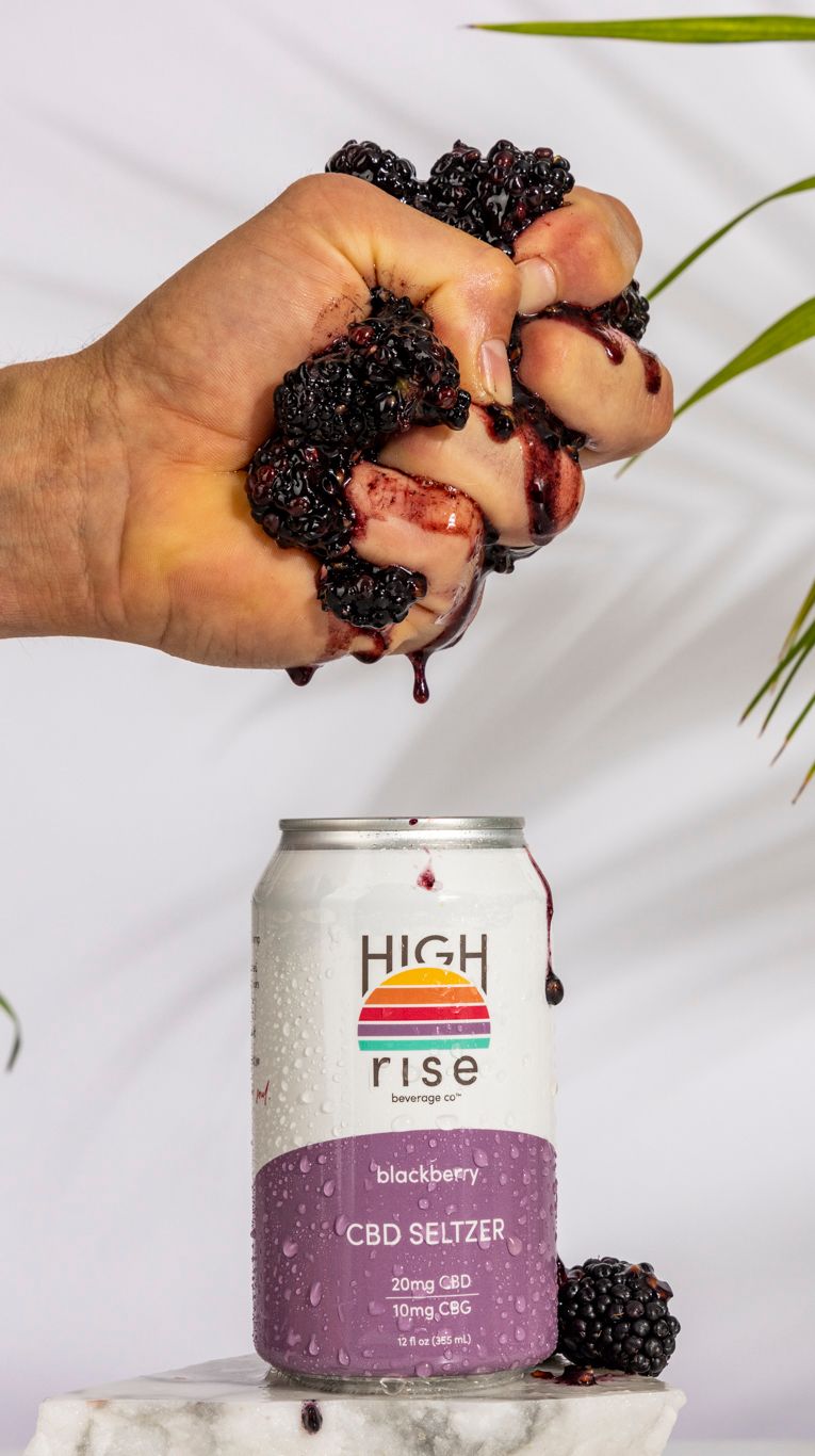 squeezing blackberries into can