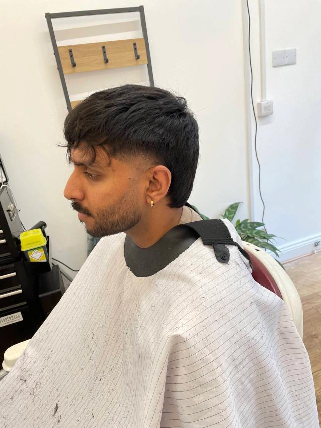 Dark mullet with a burst fade and shaped fringe