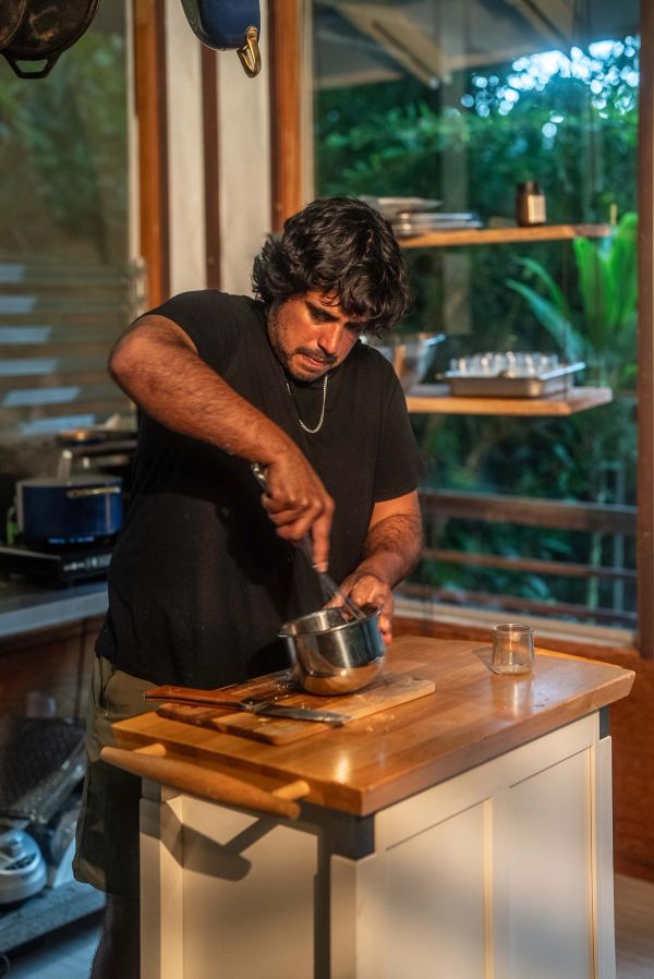 Chef Yuda Abitbol stirring a saucepan during the cooking shoot.