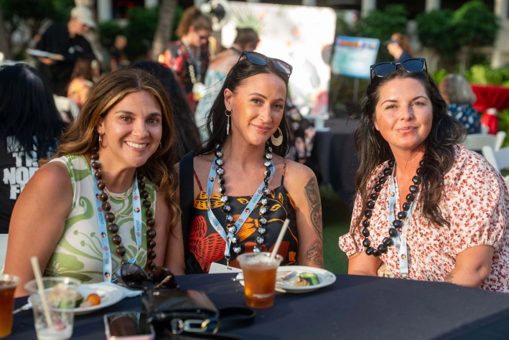 Three attendees gather at NNAHRA’s outdoor reception.