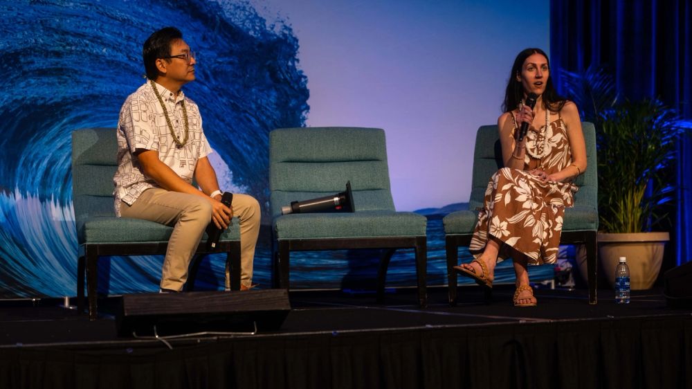 Two speakers take part in a panel at East Meets West.
