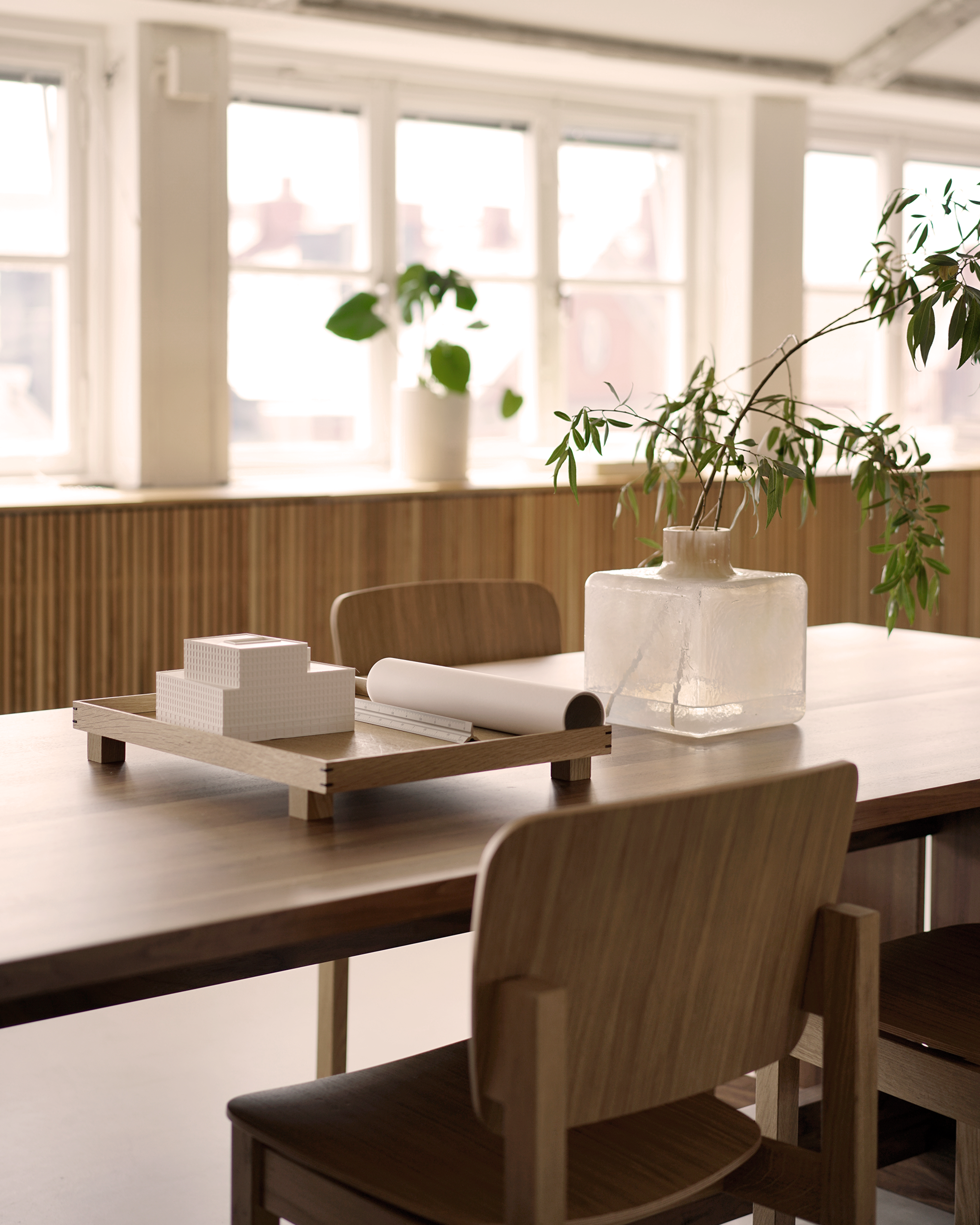 Cube Vase, by Carina Seth Andersson, on the Grande Table surrounded by Mono Wood chairs.