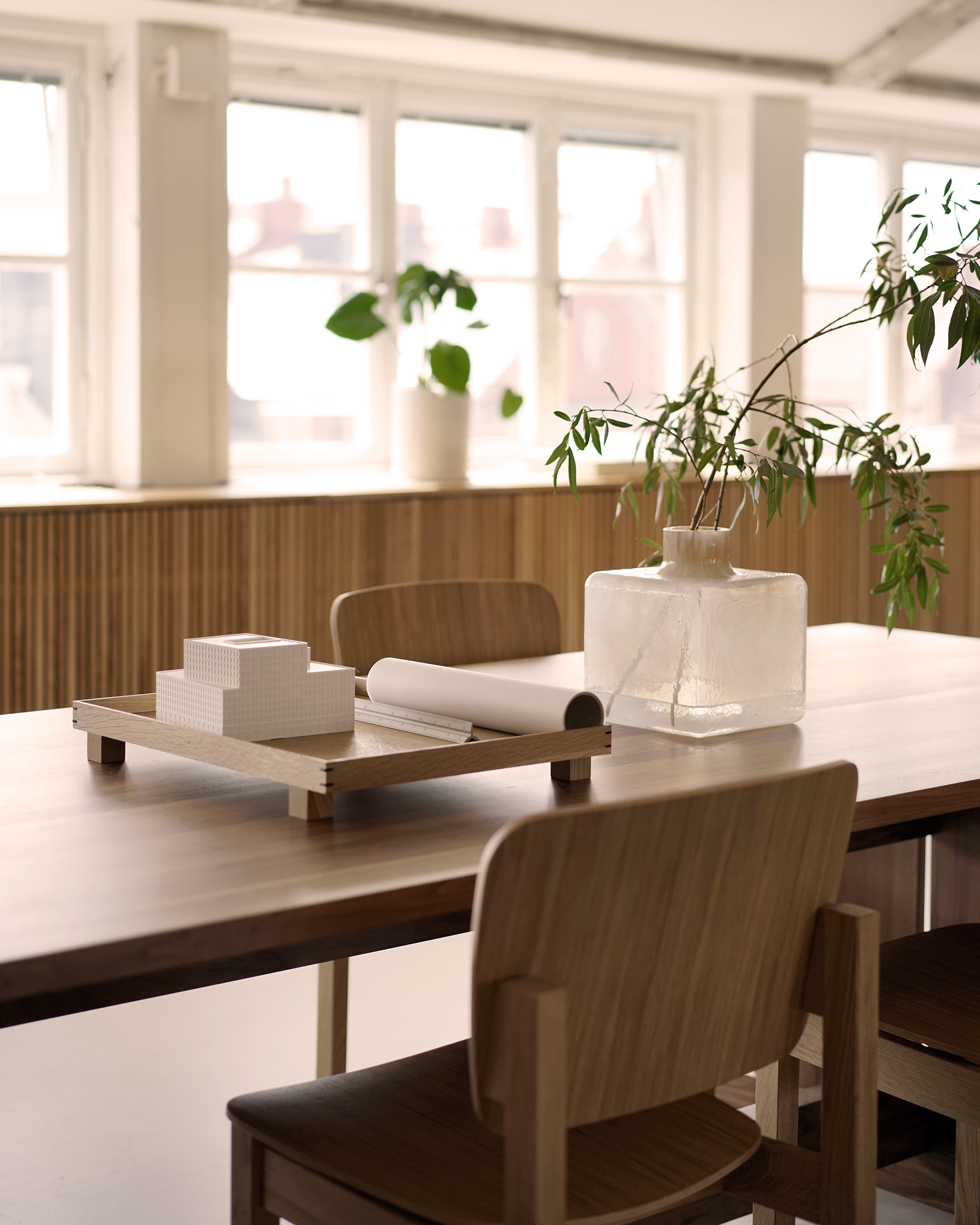 Cube Vase, by Carina Seth Andersson, on the Grande Table surrounded by Mono Wood chairs.