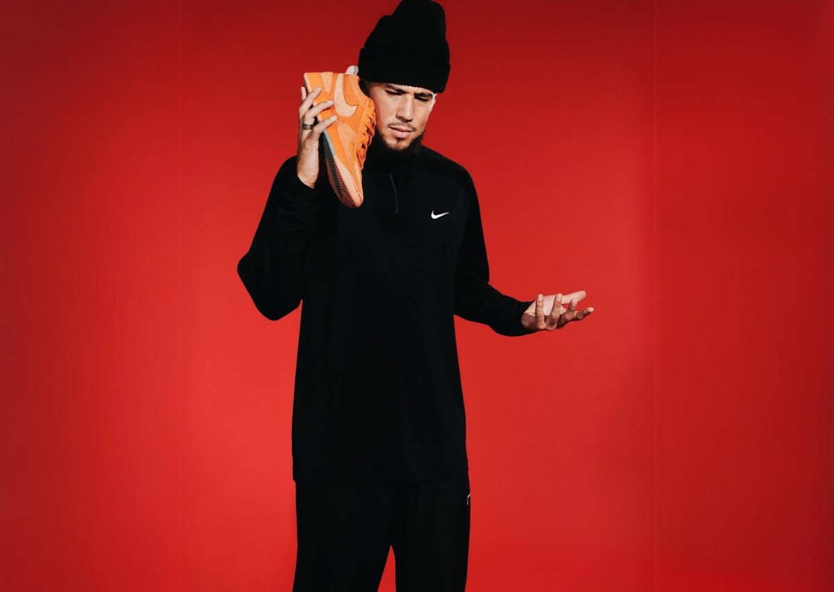 Devin Booker Posing With The Nike Book 1 Clay Orange