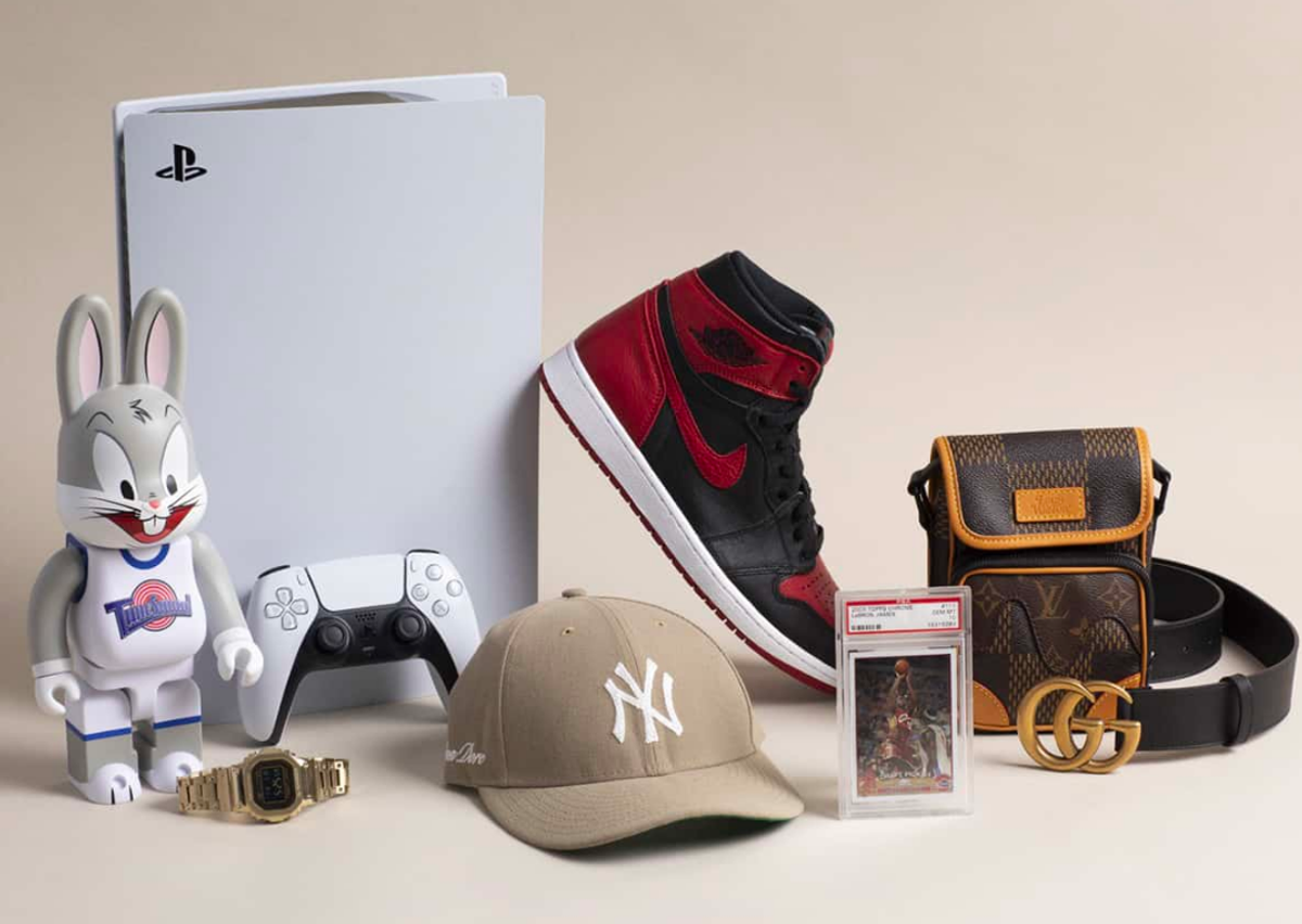 Playstation, Medicom Brick, Apple Watch, ALD Yankees Hat, Jordan Card, LV Purse, Gucci belt, and Jordan 1 OG sneaker.