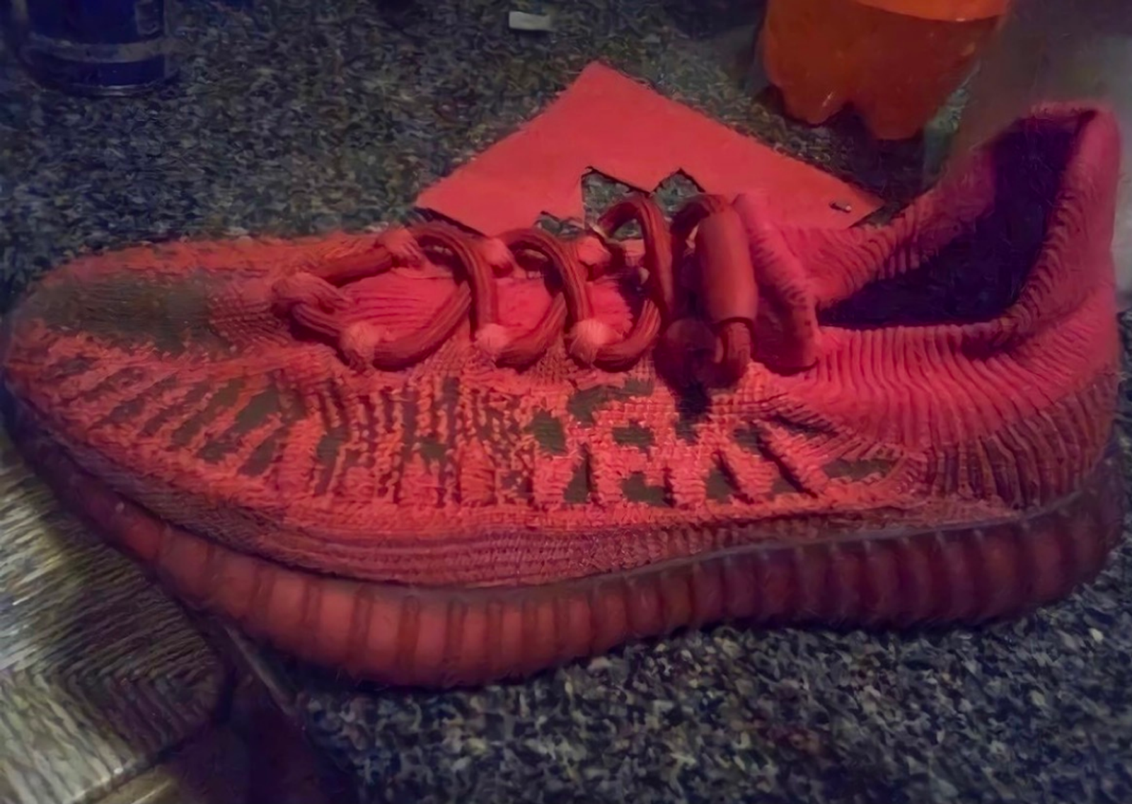In hand image of the adidas Yeezy 350 V2 CMPCT Slate Red