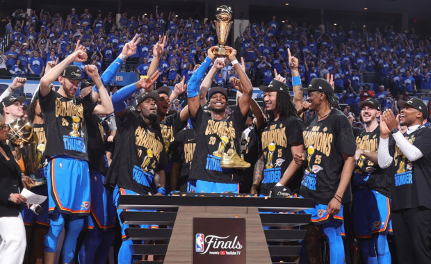 Shai Gilgeous-Alexander holding the Larry O'Brien trophy after Oklahoma City's win in the NBA Finals