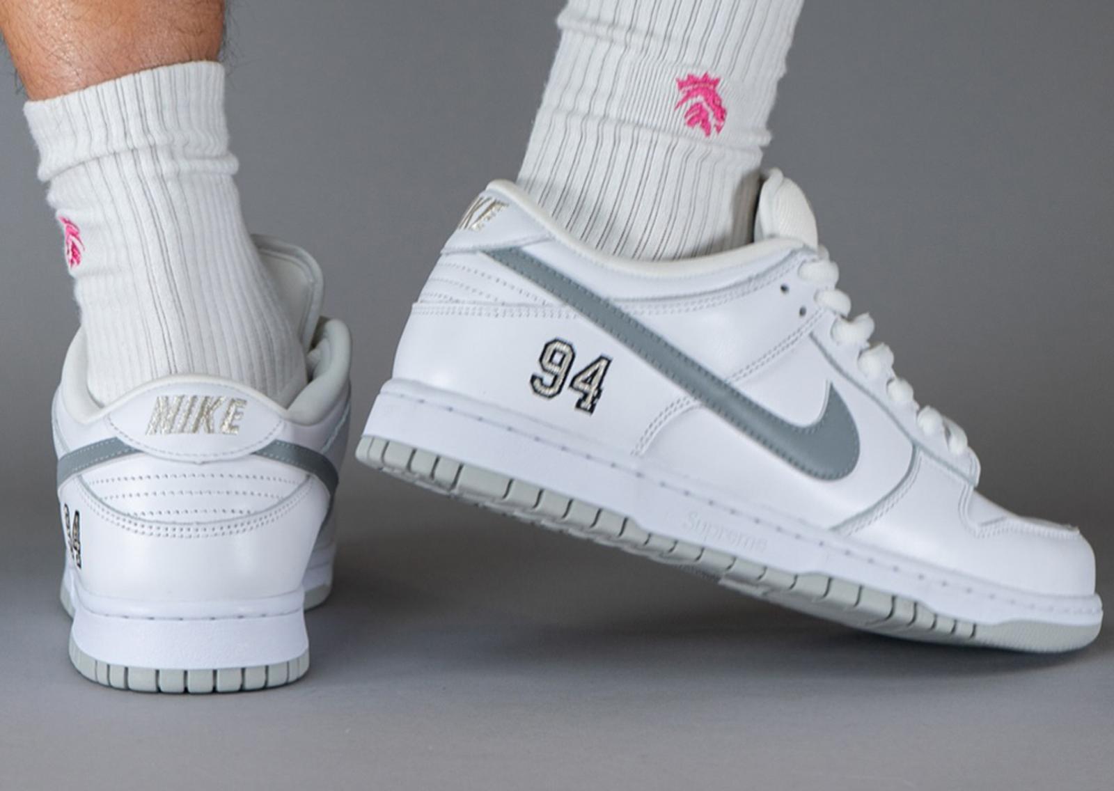 Supreme x Nike SB Dunk Low White Metallic Silver Heel Angle