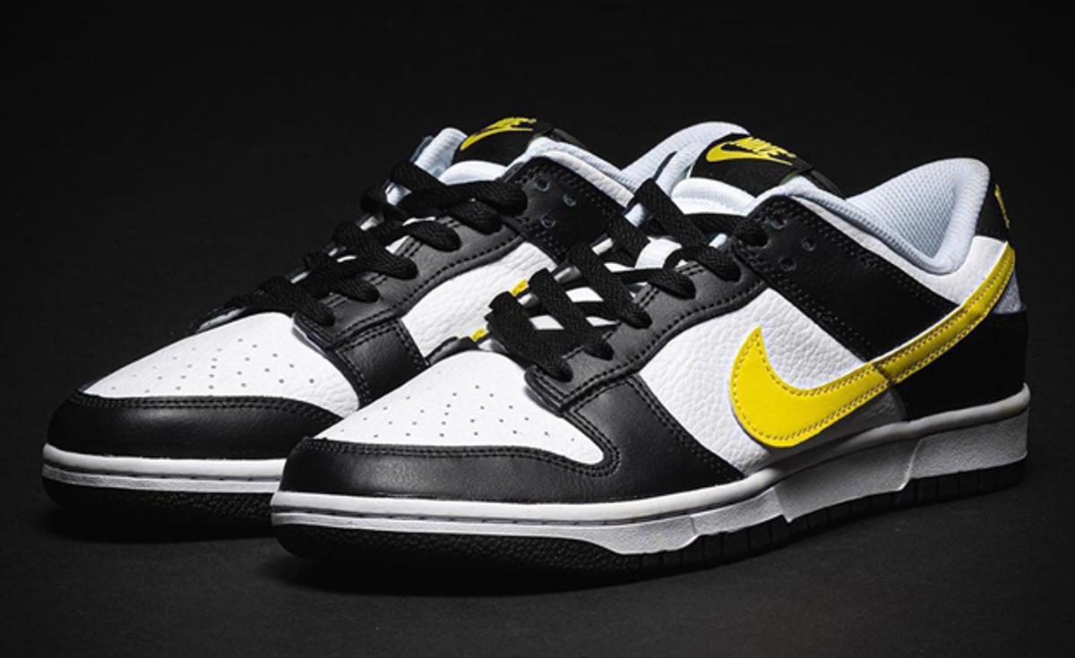 Yellow Branding Details Appear On This Black And White Nike Dunk Low