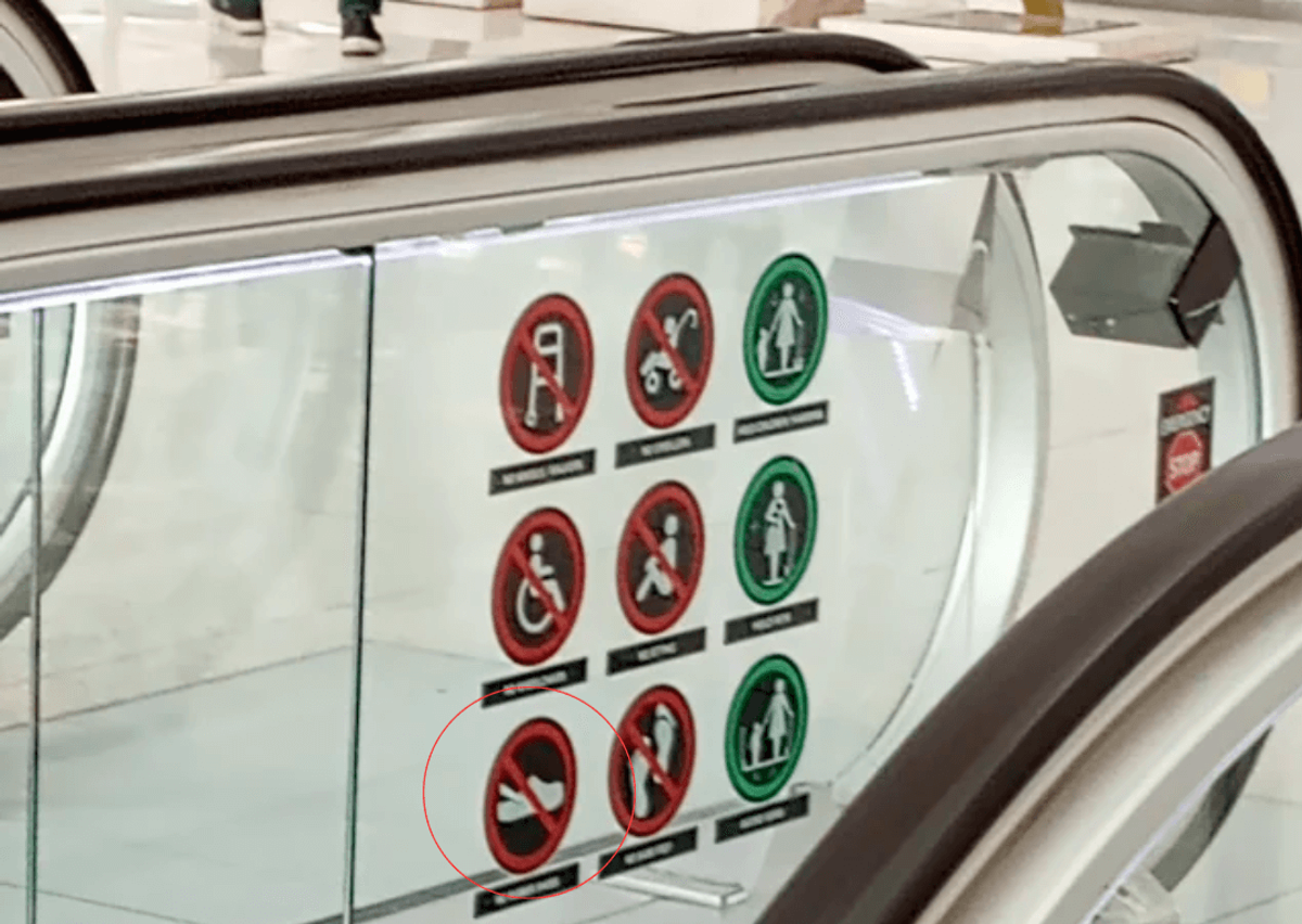 Crocs Prohibited Sign On Escalator (Image via 