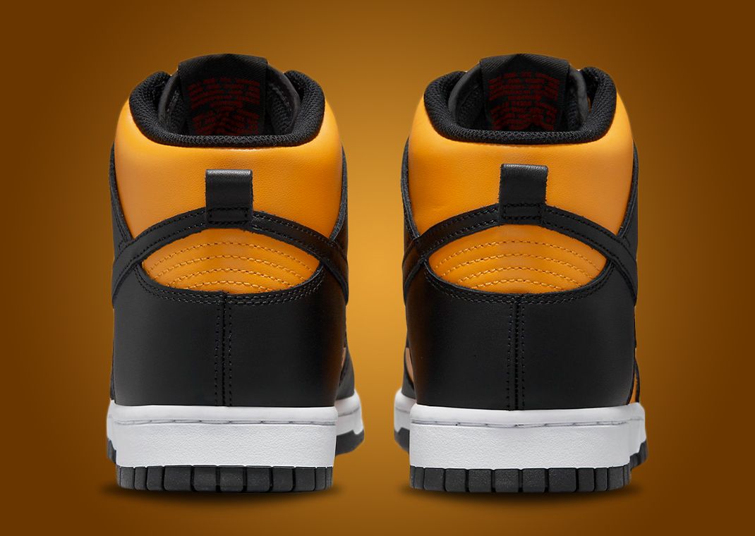 This Nike Dunk High Is Dressed In University Gold Black