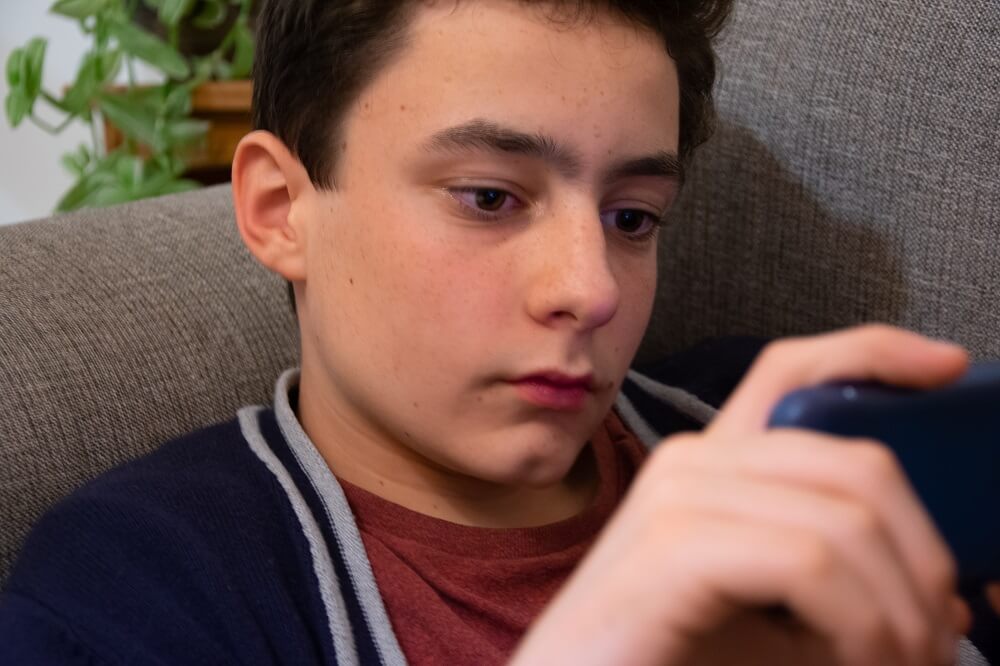 Teen boy being cyber bullied