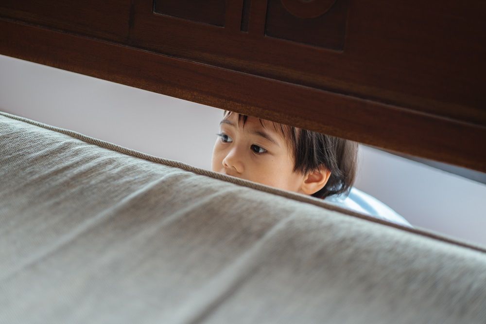Young boy with ADHD hiding