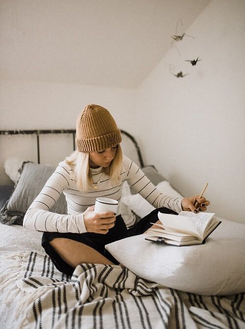 Teenage girl at home alone writing 