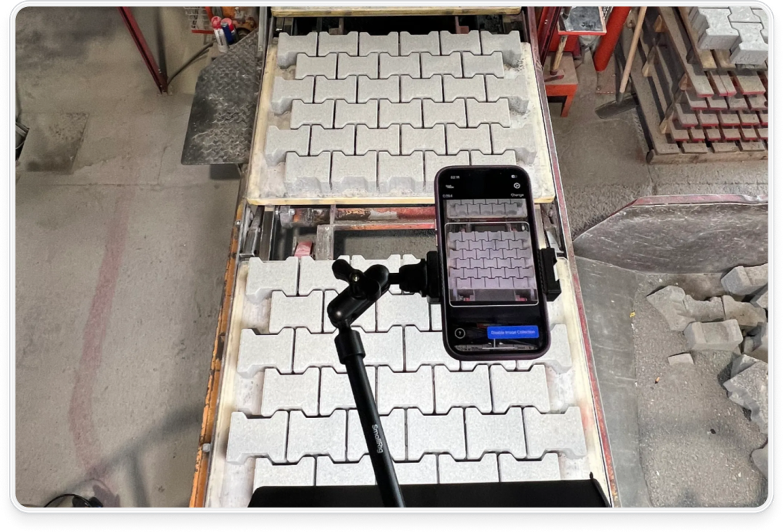 An iphone placed over factory products uses machine vision systems to automate quality inspection for defects 