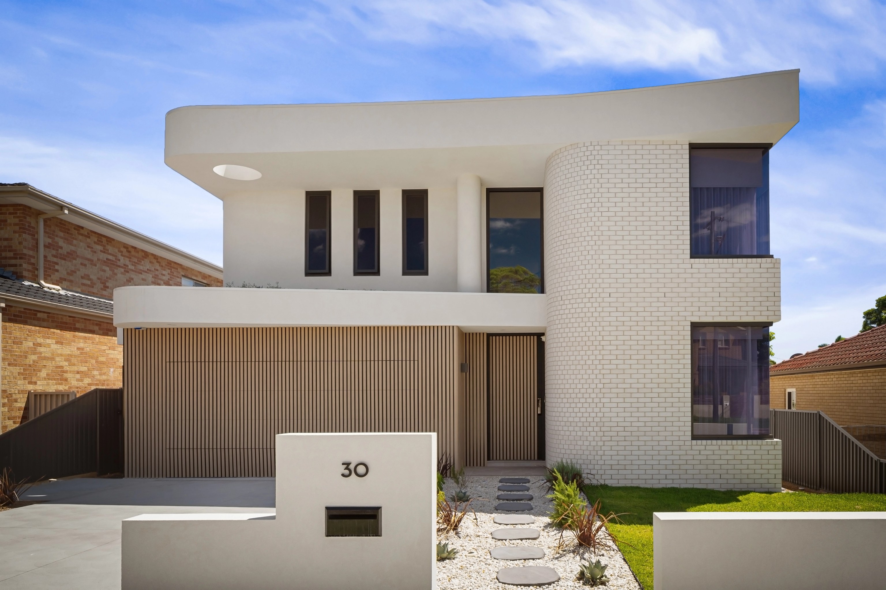 CHALK in Beverly Hills with curved white brickwork and timber battens across the facade