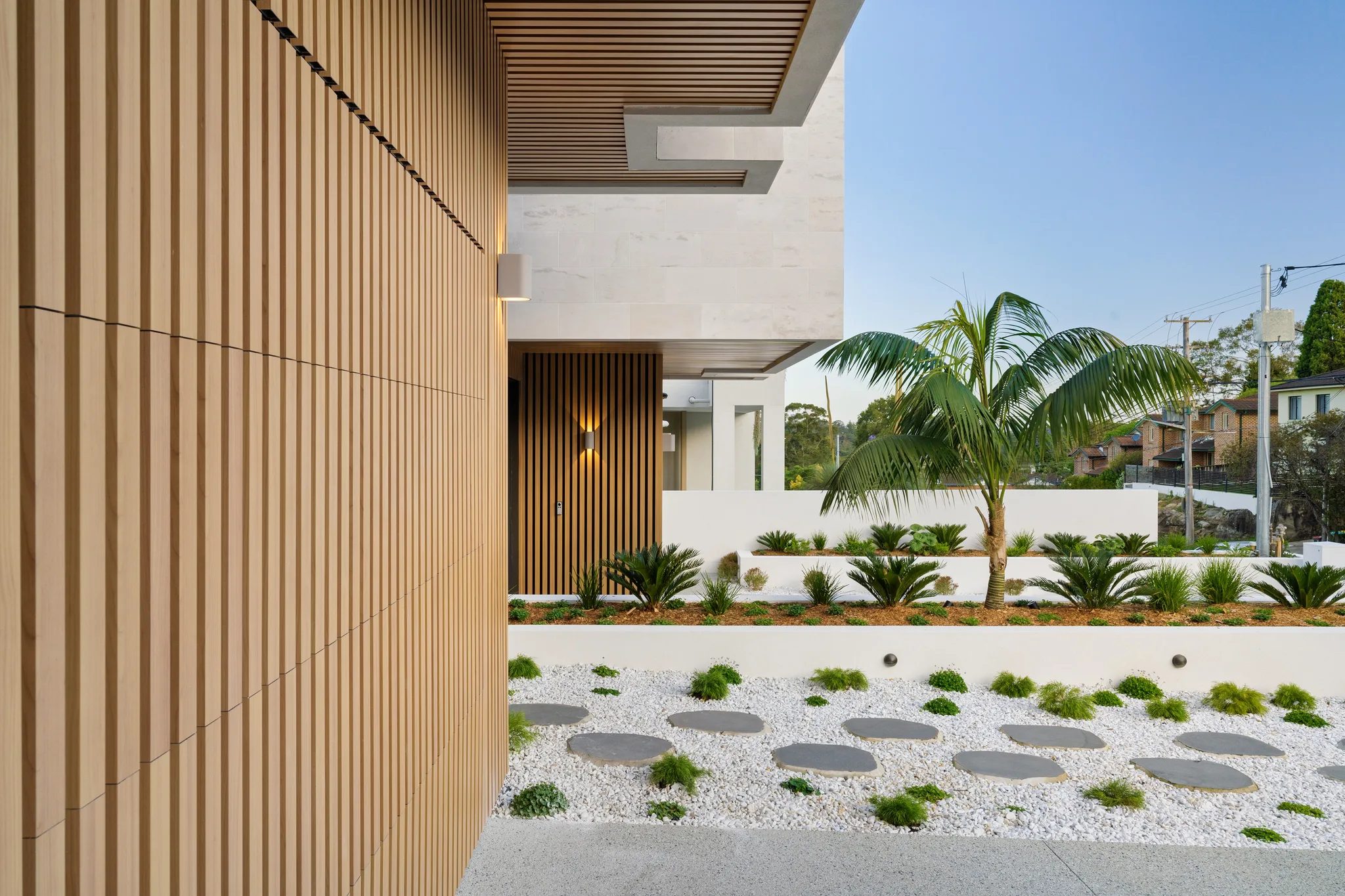 Timber battens and limestone beside the planted entrance to LIME in North Ryde