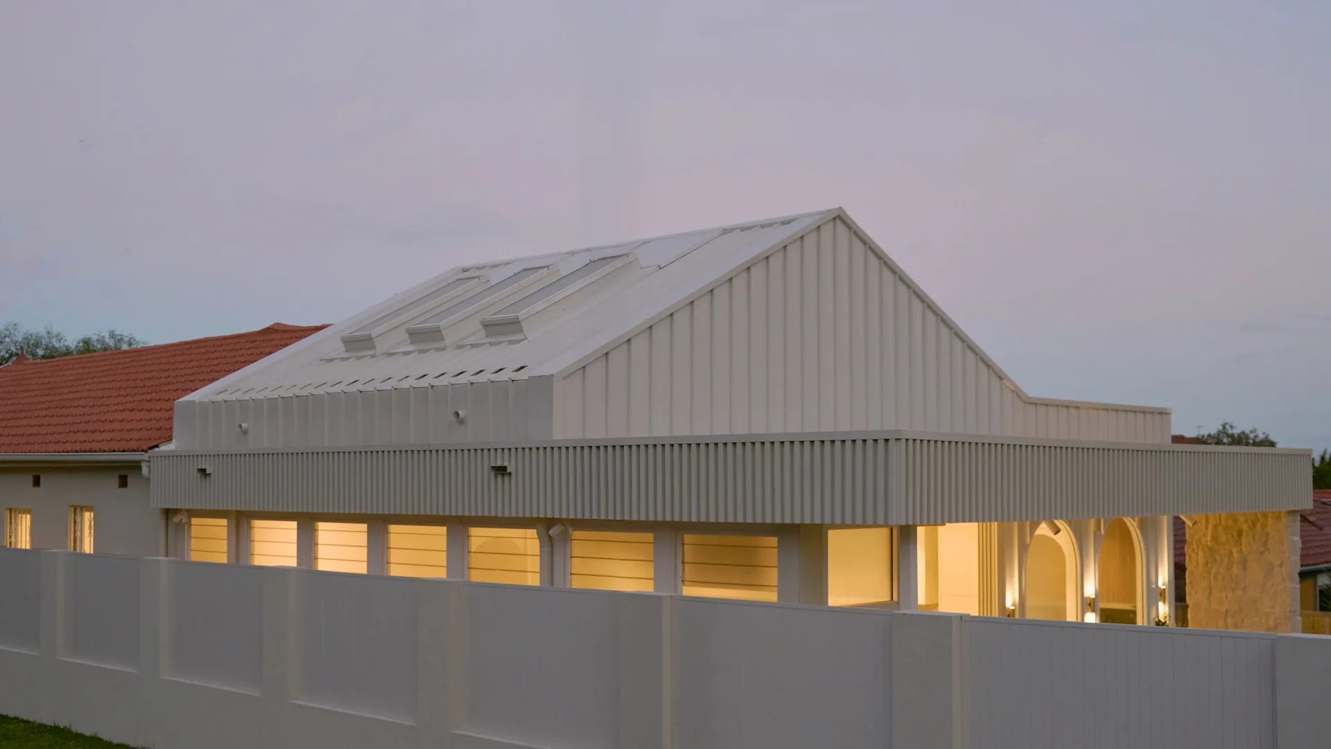 CONWAY at dusk, the contemporary extension rising behind the original Federation roof in Randwick