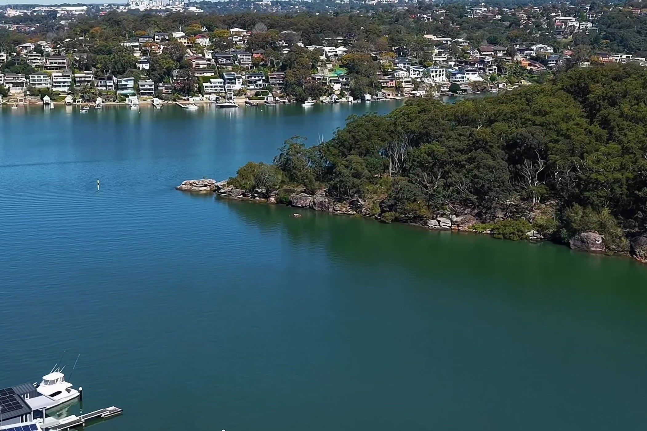 Aerial of the Georges River at Connells Point, a bush headland and waterfront homes