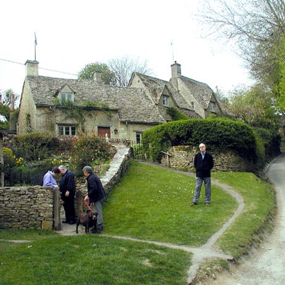 Traditional stone cottages beside the river in Bibury, Cotswolds
