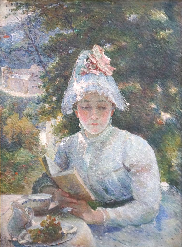 Woman seated reading in a painted scene