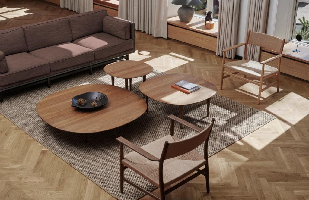 Low sofa tables in smoked oak on sisal carpet and herringbone wooden floor