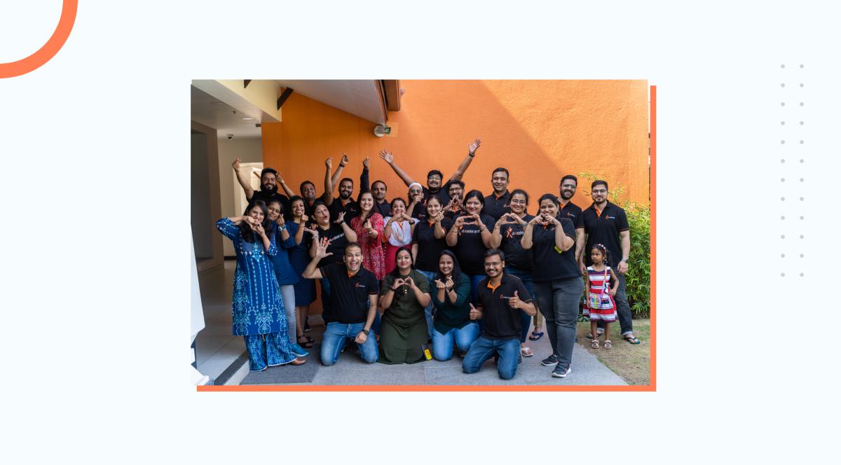 A group of team members happily posing for a picture