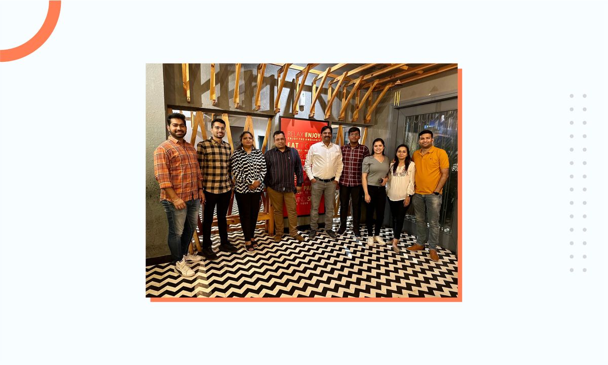 Abhishek with his team members in a restaurant
