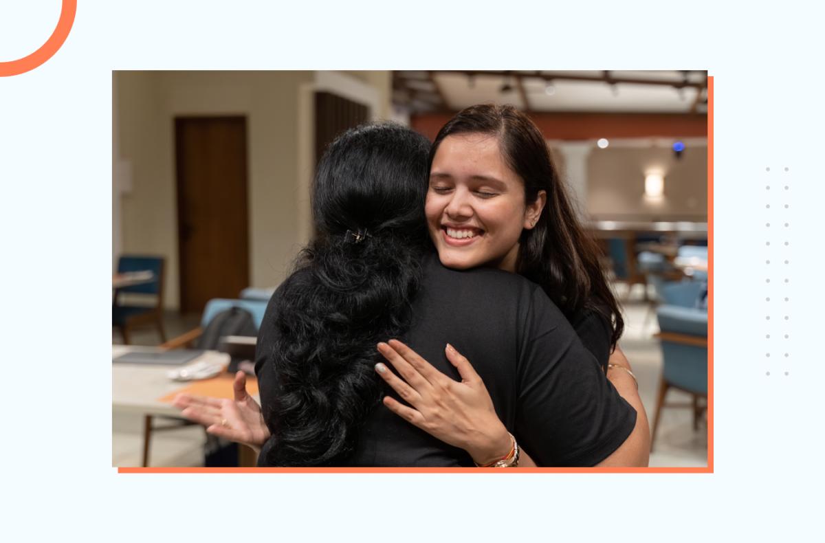 Two team members bonding through warm embrace