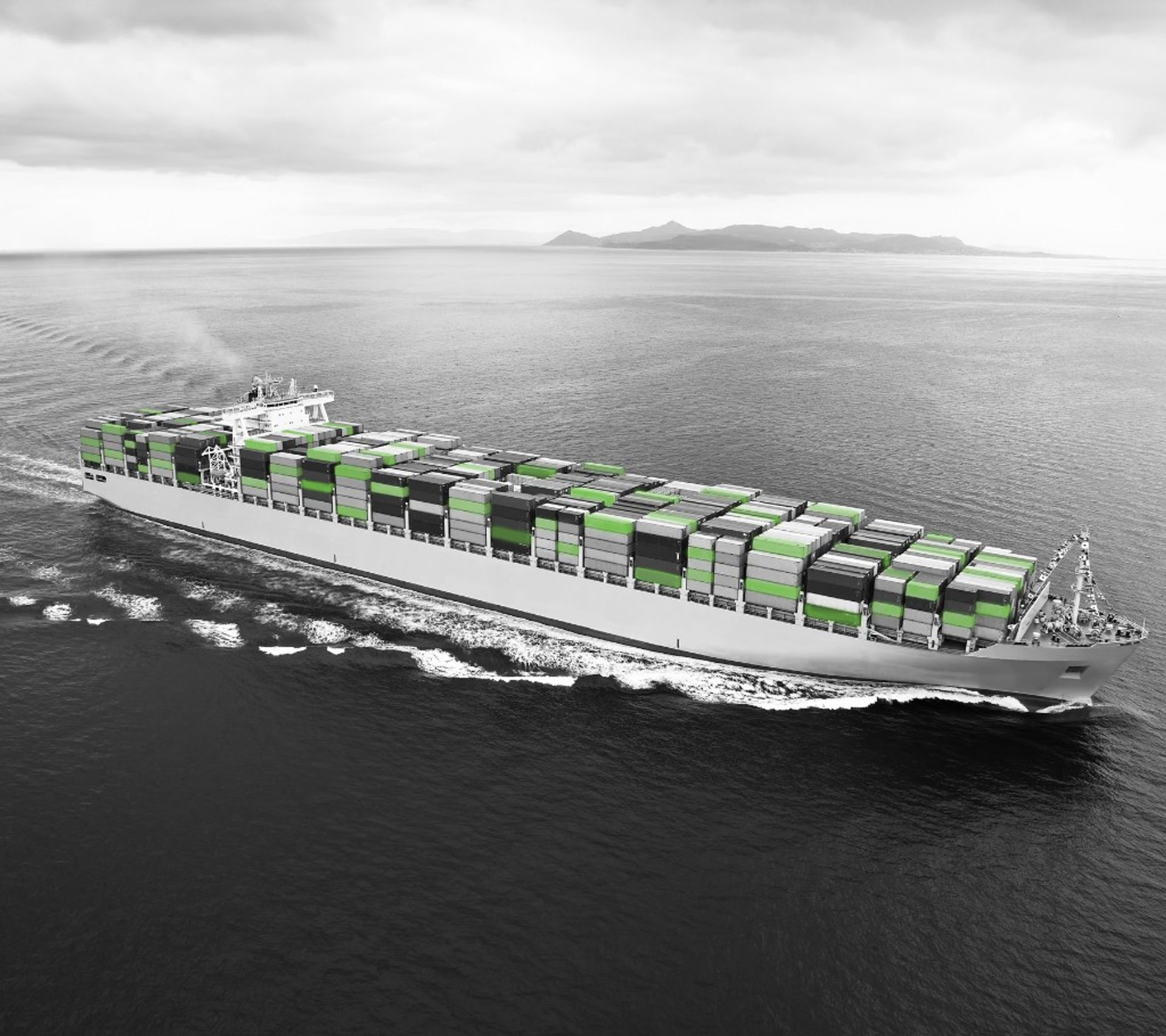 Container ship with green containers on open seas