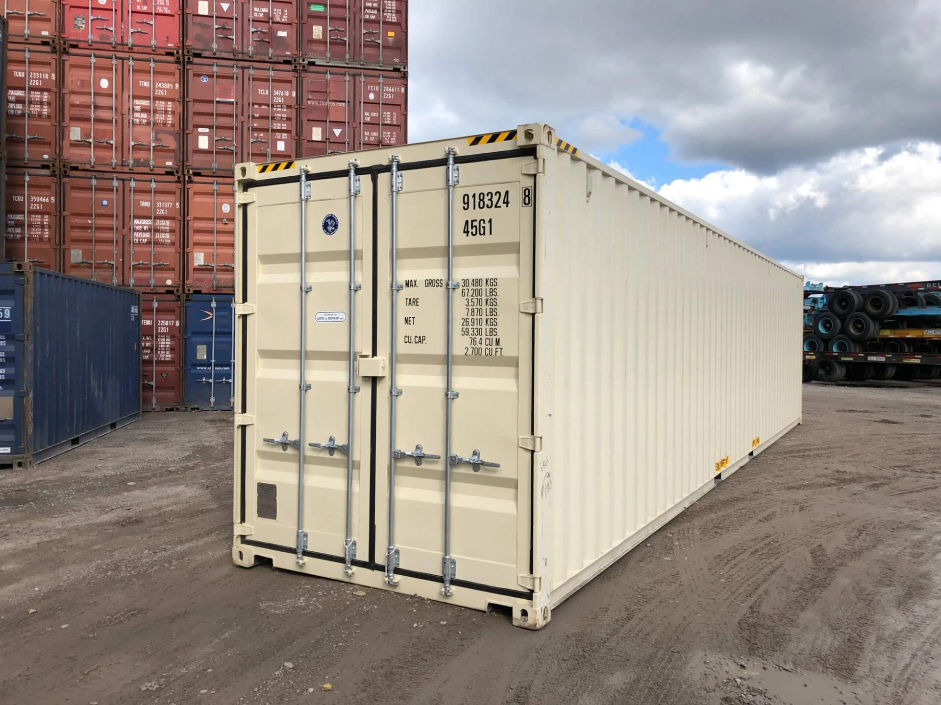 Used shipping container for sale at intermodal depot with container doors facing camera and a stack of used shipping containers behind