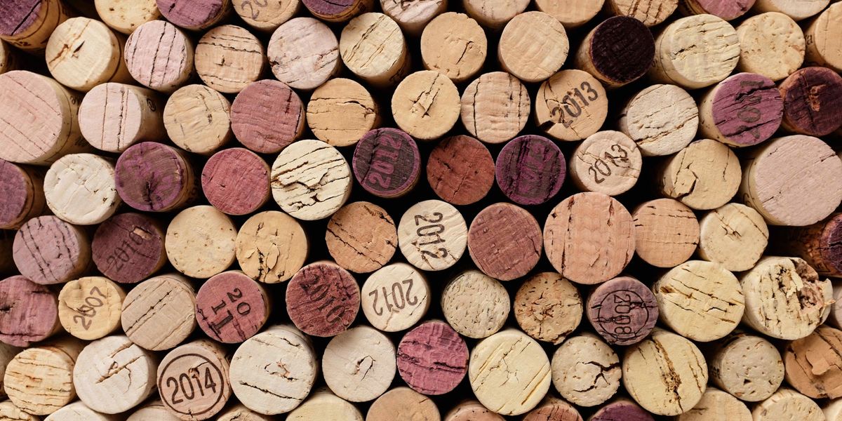 A collection of used wine corks stamped with vintages ranging from 2007 to 2014.
