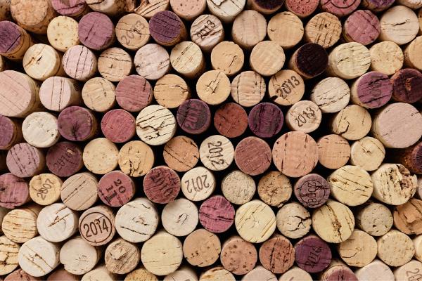 A collection of used wine corks stamped with vintages ranging from 2007 to 2014.