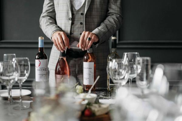 Wine bottles displayed on a table set with glasses at a formal tasting.