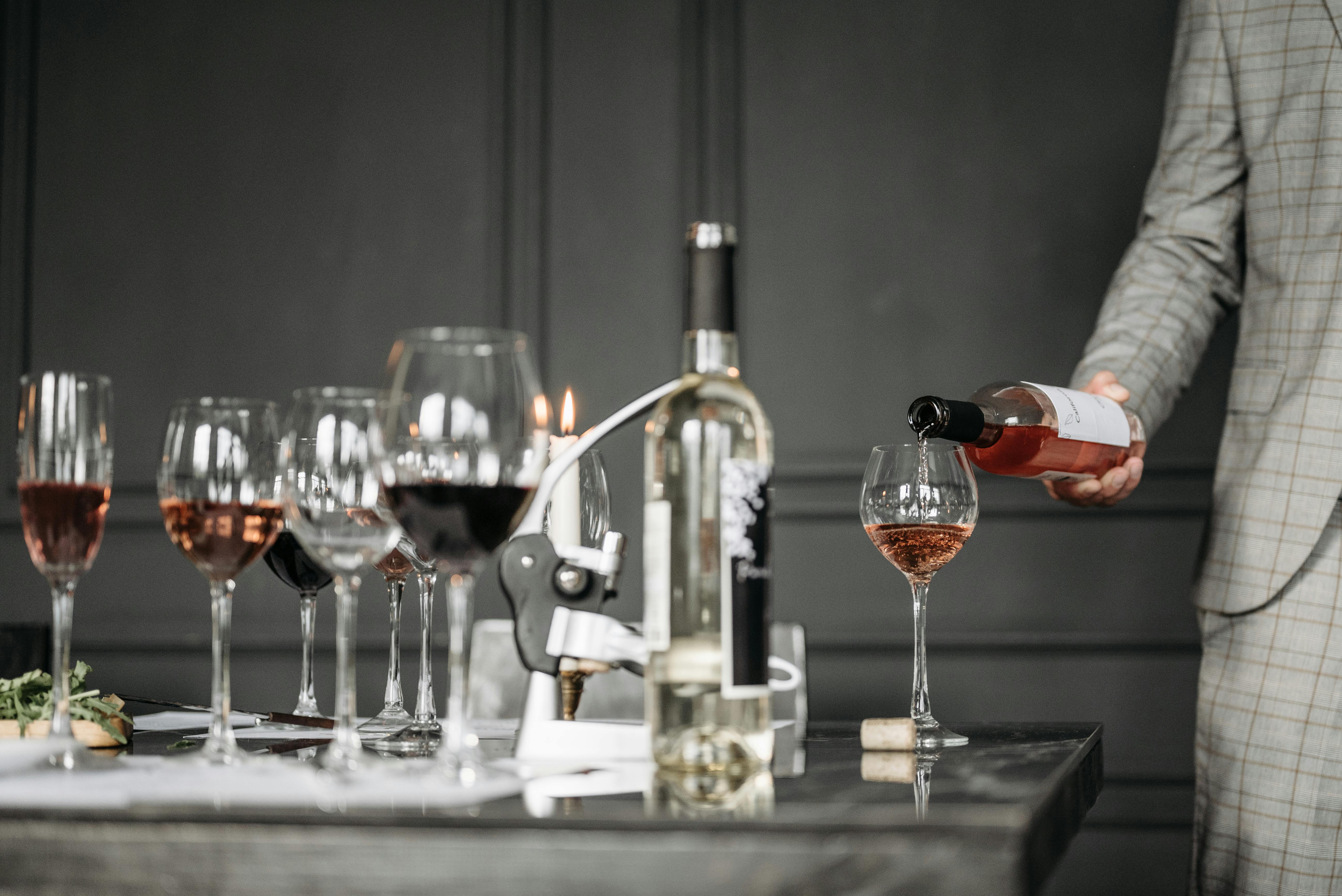 A table full of wine glasses and wine bottles.