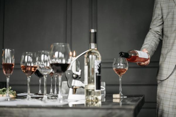 A table full of wine glasses and wine bottles.