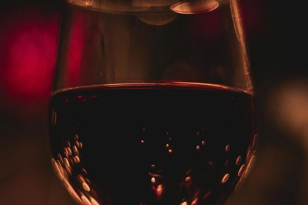 A closeup of a wine glass full of red wine.