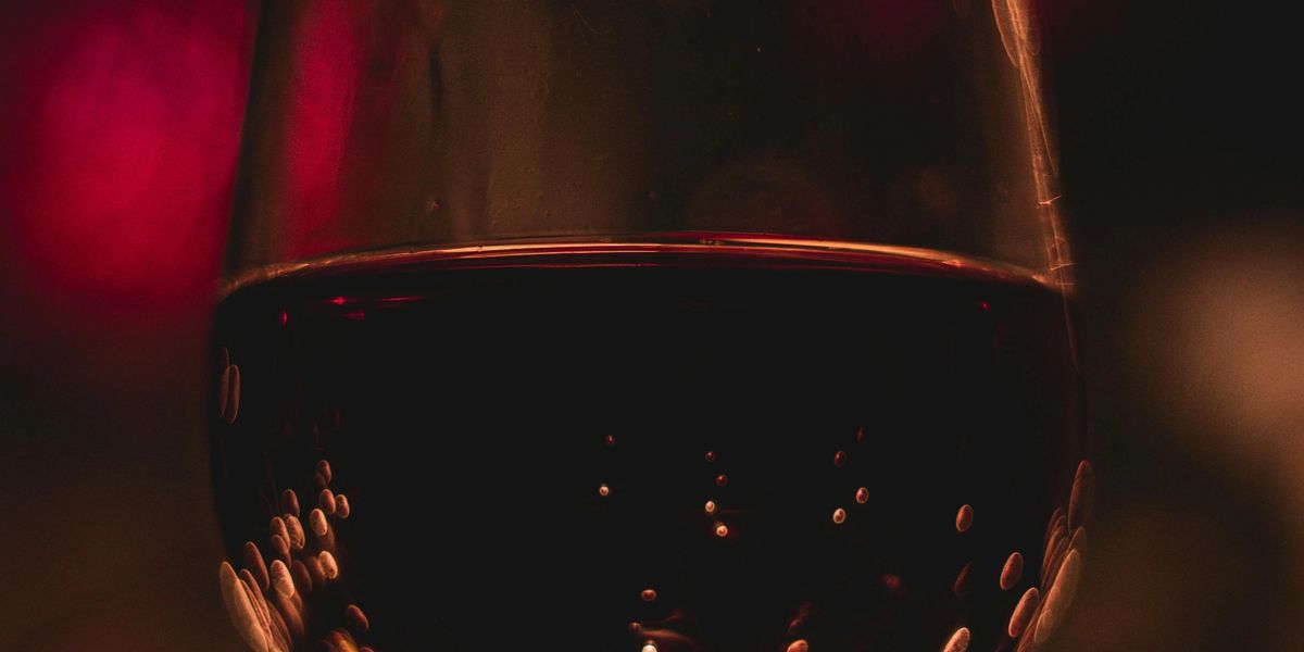 A closeup of a wine glass full of red wine.