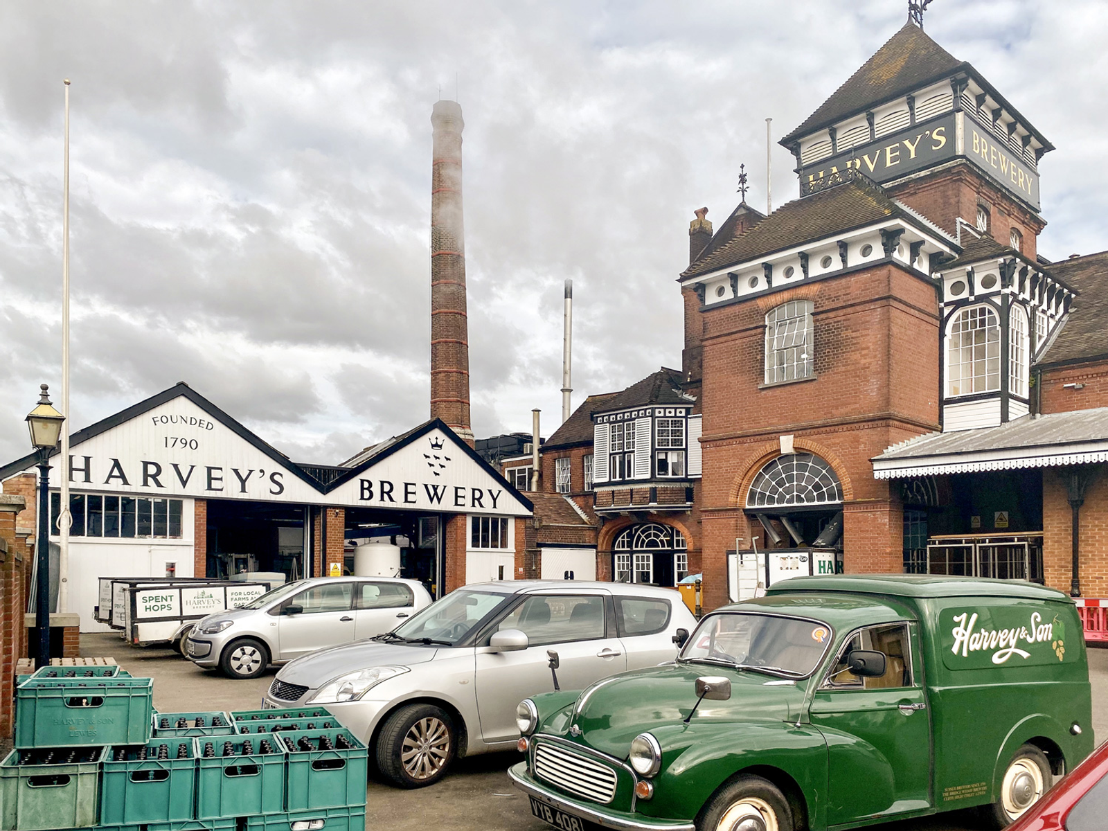 An old classic van in front of Harvey's Brewery on a cloudy day