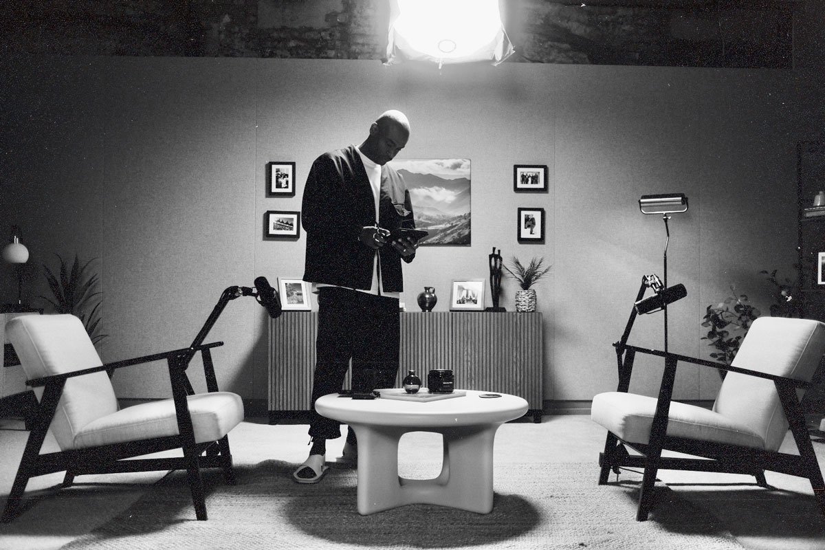 A man standing in a black and white studio