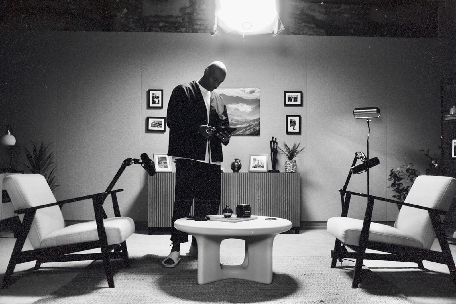 A man standing in a black and white studio