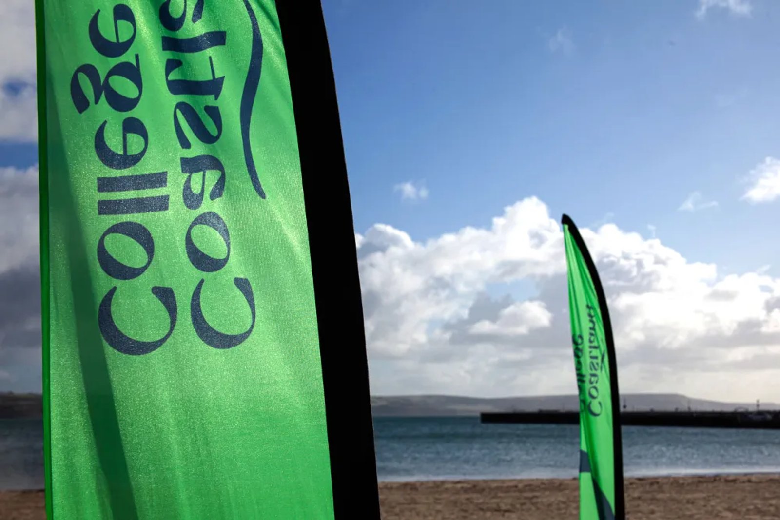 A flag printed with the Coastland College name