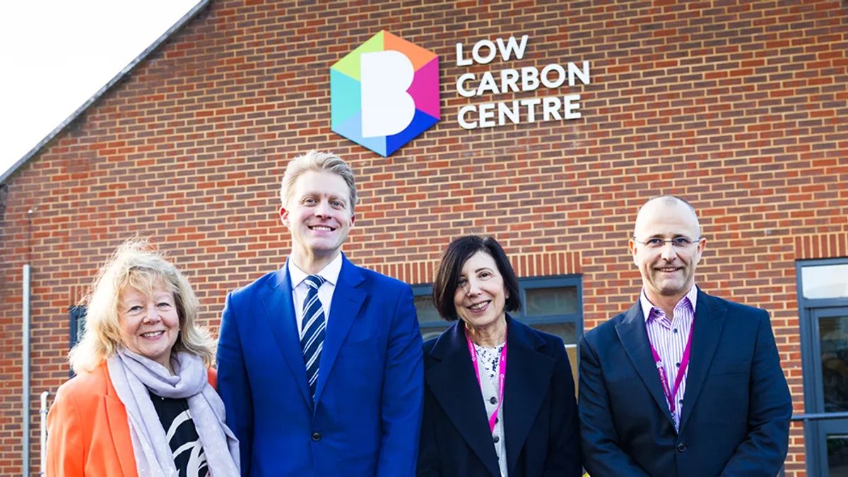 Four people stood in front of the low carbon centre at Brooklands
