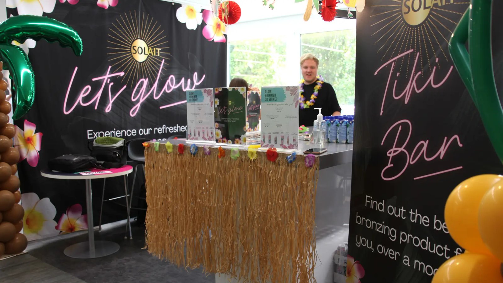 Solait presentation stall with products, wall graphics and tropical decoration all around